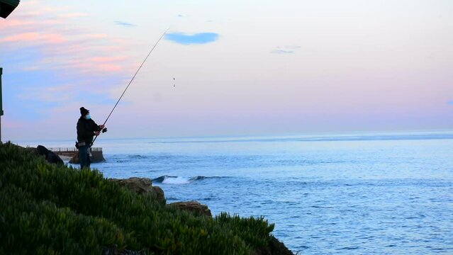 Fisherman Casting Rod into Pacific Ocean at La Jolla California