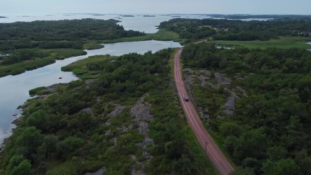 Car driving in Brando Island in Aland Islands, Finland, aerial following shot