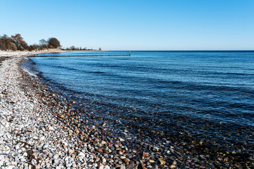 pebble beach at baltic sea against clear blue sky