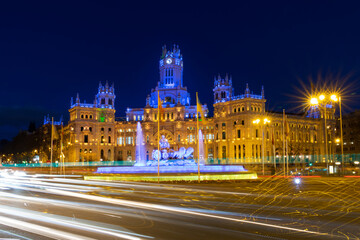 Fototapeta na wymiar City Hall of Madrid, Spain illuminated at night in blue and yellow with a flag of Ukraine