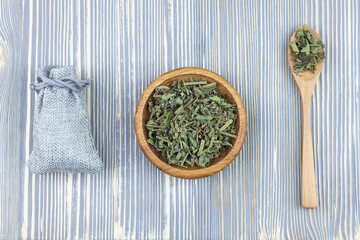 Dry herb and seasoning (spices) in a wooden bowl. Healing herbs.