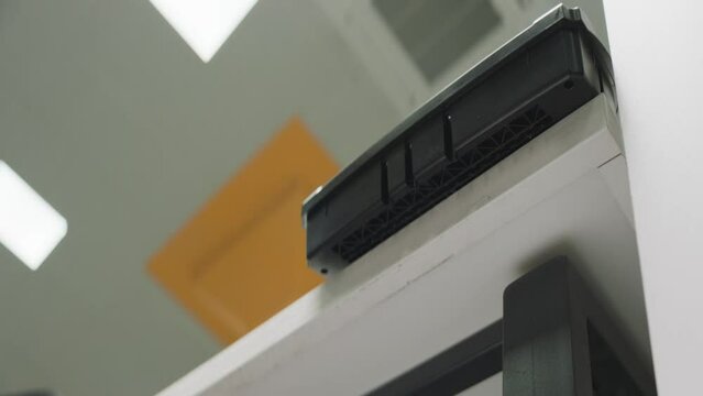 Shredder. Paper destroying machine. Process of paper cutting in the office. Low angle camera