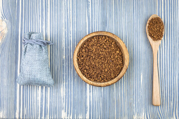 Coffee in a wooden cup on a wooden table.