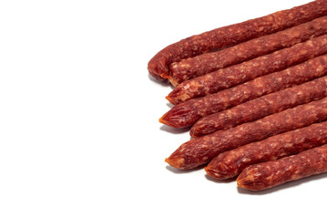 Dry sausage on a white background. Thin smoked sausages isolated
