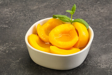 Sweet ripe canned peaches with mint