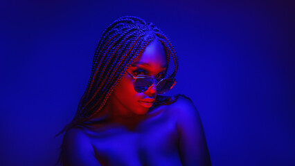 view of beautiful african young woman in colorful spot light
