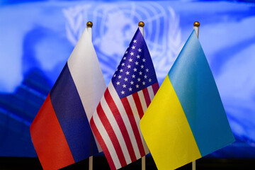The US flag, Russian flag, Ukraine flag. Flag of USA, flag of Russia, flag of Ukraine. The United States of America and the Russian Federation confrontation. Russia invasion of Ukraine. Close-up