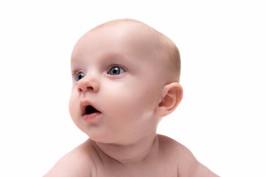 close-up portrait of a surprised breastfed baby on a white isolated background