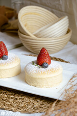 Delicious Japanese fluffy souffle pancakes on white cafe table.