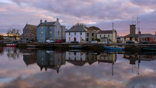 Galway, Ireland. Beautiful landscape of Galway, Ireland. River and famous painted houses with cloudy colorful sky. Time-lapse during the sunset, zoom in