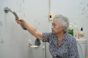 Asian senior or elderly old lady woman patient use slope walkway handle security with help support...