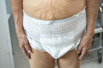 Asian senior or elderly old lady woman patient wearing incontinence diaper in nursing hospital...