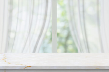 Marble table top on blur room interior with window curtain background