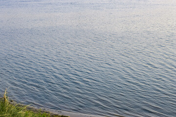 Beautiful riverbank in the evening with calm blue water