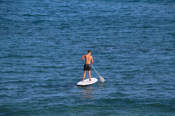 Man on stand up paddleboard (SUP) paddling at the Atlantic ocean  (Tenerife, Spain) - 491683296