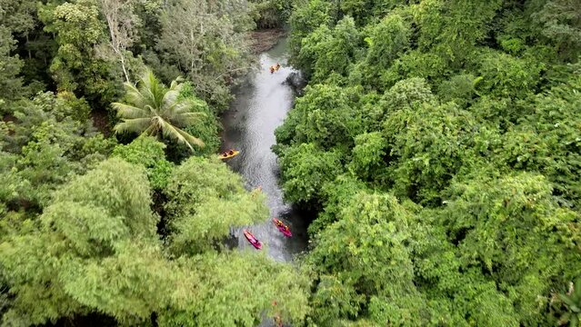 Aerial view 4k resolution footage by drone is Tourists rafting in canoes is fun at "Nhan Mod Dang" river in Papayom city, Phatthalung province, Thailand.
