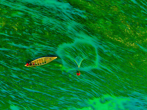 Aerial view of fishermen on a canoe sailing the Jamuna river, Bangladesh.