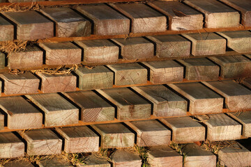 Old sawn timber material - stack of weathered wooden planks