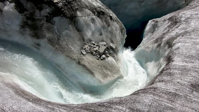 Powerful mountain river of melting ice in Mer de Glace glacier, Chamonix, France.