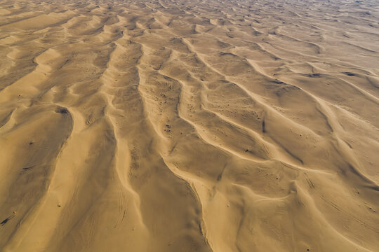 Aerial view of sand dunes in the desert at sunset, Dubai, United Arab Emirates.