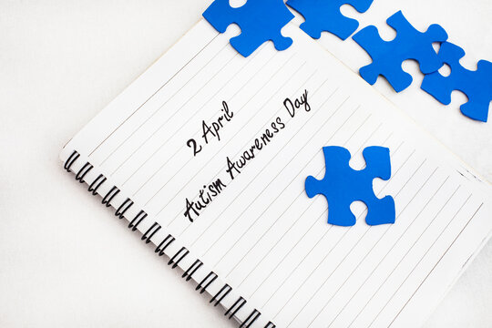2April Autism Awareness Day written on notebook