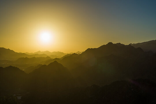 Aerial view of a mountain landscape at sunset near the desert, Dubai, United Arab Emirates.