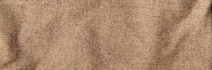 fabric grunge background, real cotton denim brown, wrinkled, frayed, close