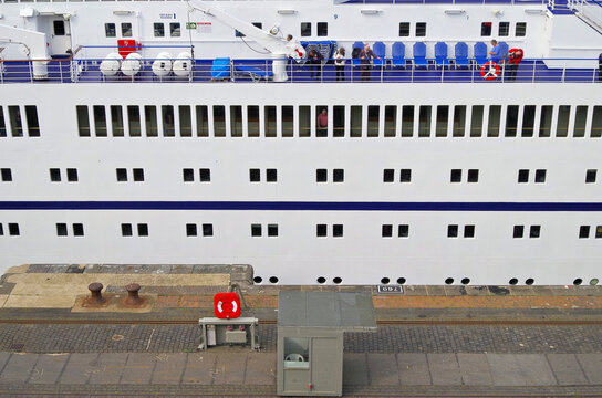 Classic cruiseship cruise ship liner Berlin in Bremerhaven port with infrastructure, terminal and other ships on sunny day with blue sky and close up details of vessel superstructure and funnel