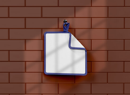 Blue Oven Mitt Hung On Brick Wall