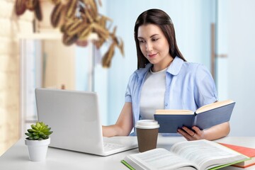 Beauty student girl in studying foreign language, lesson at laptop, reading notes out loud, doing exercises from open book