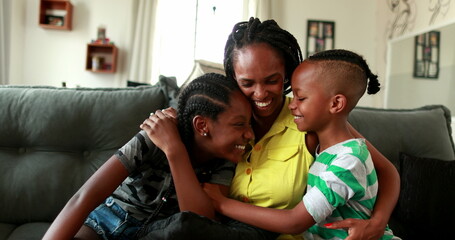 African mother embracing teen daughter and little boy son. African black ethnicity, love and affection - Powered by Adobe