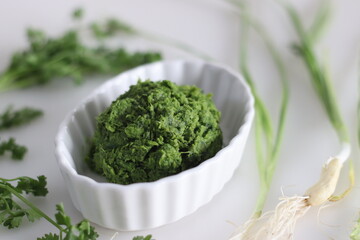 Spicy green garlic condiment, prepared with spring garlic, coriander leaves, green chillies and coconut oil.