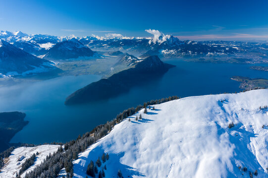 Aerial view of Vierwaldstattersee lake in wintertime with snow, a lake between Switzerland and Italy border.