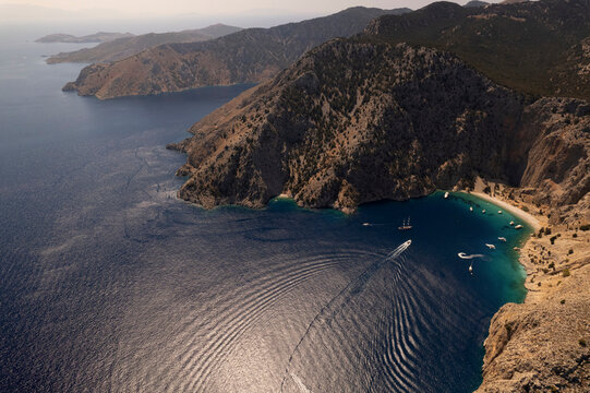 Aerial view of a few sailboat at Saint George Bay, Symi island, Greece.