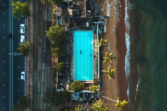 Aerial top down view of public open air swimming pool on the beach in Wellawatte district, Colombo city, Sri Lanka.