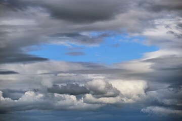Bright landscape of white puffy cumulus clouds on blue clear sky