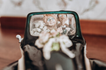 porcelain bride and groom on a retro car - Powered by Adobe