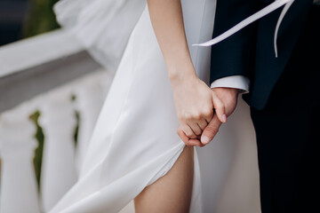 Bride and groom holding hands outdoors,  wedding theme