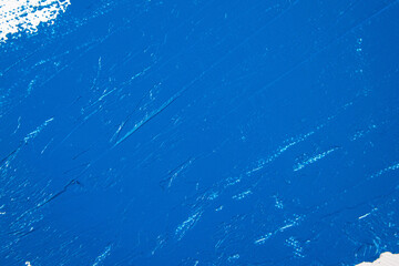 deep blue abstract background, applied toning primer on a white surface