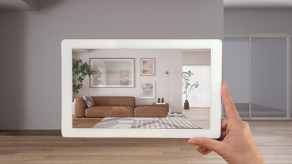 Augmented reality concept. Hand holding tablet with AR application used to simulate furniture products in custom architecture design, black ink sketch, modern living room with sofa