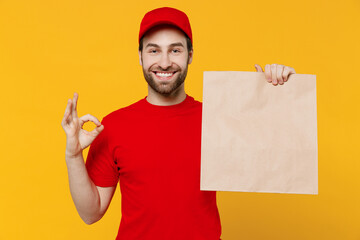Delivery happy guy employee man in red cap T-shirt uniform workwear work as dealer courier hold...