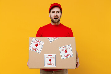 Professional puzzled confused sad delivery guy employee man wearing red cap T-shirt uniform...