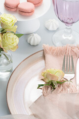 Beautiful and romantic table setting in light pink colors. Holiday table decoration. Selective focus..