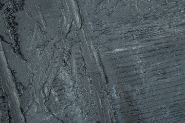 abstract background: black textured plaster, close