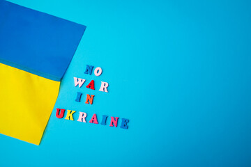 No war in Ukraine. Ukrainian yellow blue flag during war with Russia. Russian attack and escalation. Space mockup