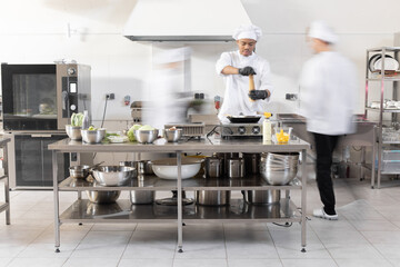 Chef cooks working in professional kitchen. Chefs hurry up, actively cooking meals for restaurant....