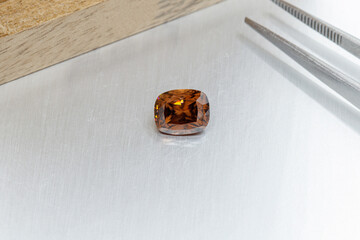 macro mineral faceted stone cut Zircon on a gray background