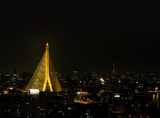 Rama VIII Bridge with Bangkok skycrapers at night, Bangkok, Thailand 01.25.2022