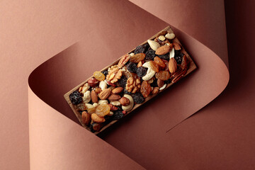The mix of dried fruits and berries on a brown background.