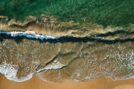 Aerial view of waves rolling on the shoreline along the beach, Hiriketiya, Sri Lanka.